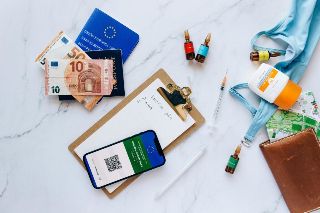 pexels photo 8830672 8830672 Flat lay of travel essentials including vaccination passport, euros, and medical supplies.